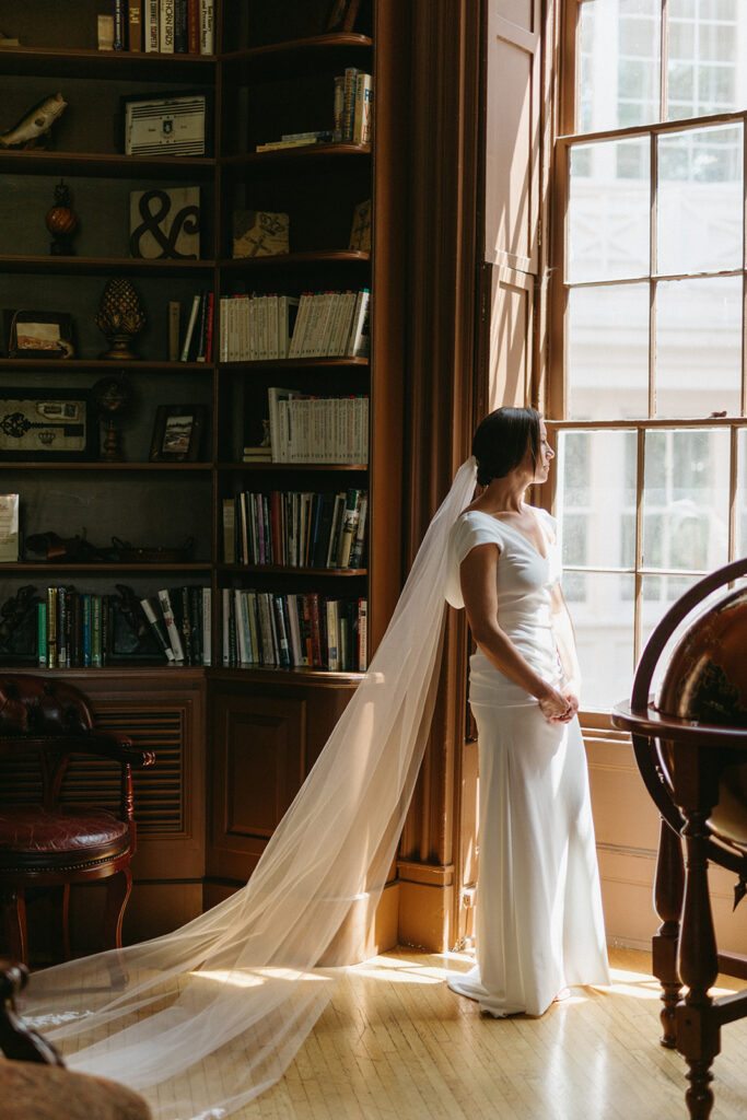 Abingdon Virginia summer wedding — bride in soft natural light by a window in the library at the Martha Washington Inn, calm and radiant.