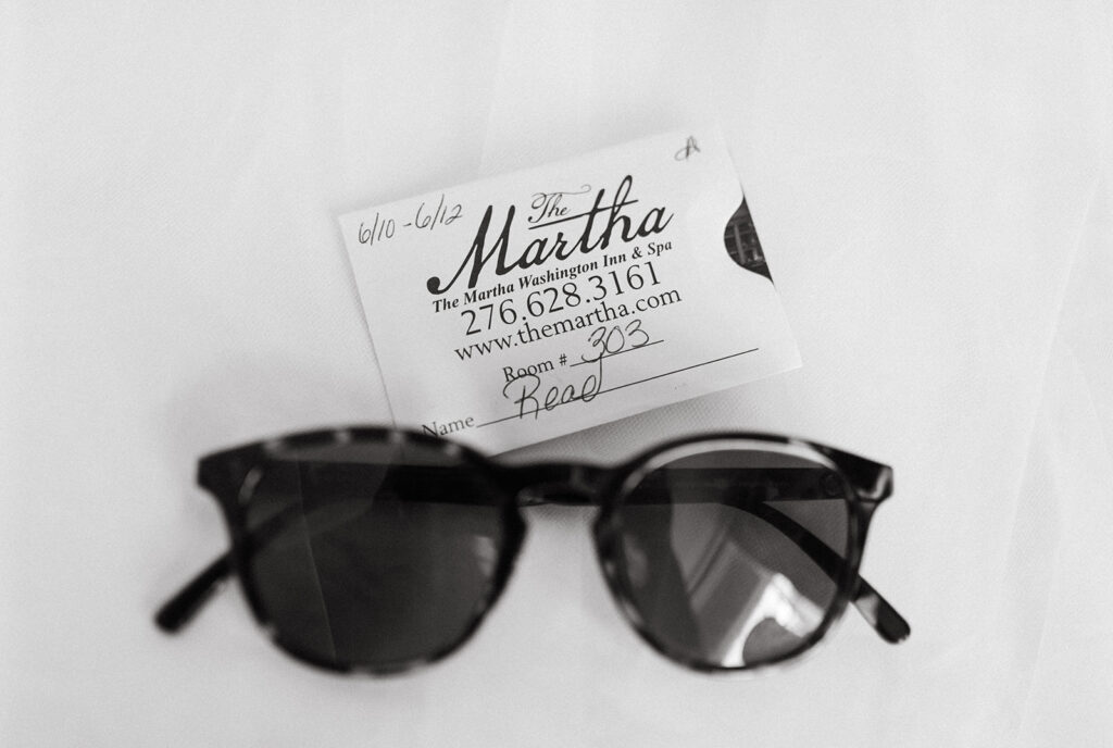 Black and white image of bride's sunglasses and room key at the Martha Washington Inn in Abingdon Virginia